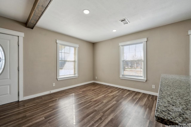 entrance foyer with beamed ceiling, plenty of natural light, and dark hardwood / wood-style flooring