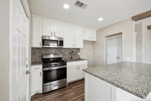 kitchen featuring stainless steel appliances, white cabinetry, and sink