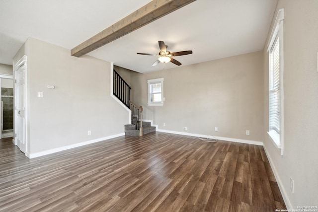 unfurnished living room with ceiling fan, dark wood-type flooring, and beamed ceiling