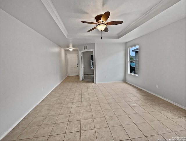 unfurnished room featuring crown molding, light tile patterned floors, a tray ceiling, and ceiling fan