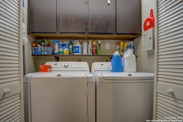 laundry room featuring cabinets and washer and dryer