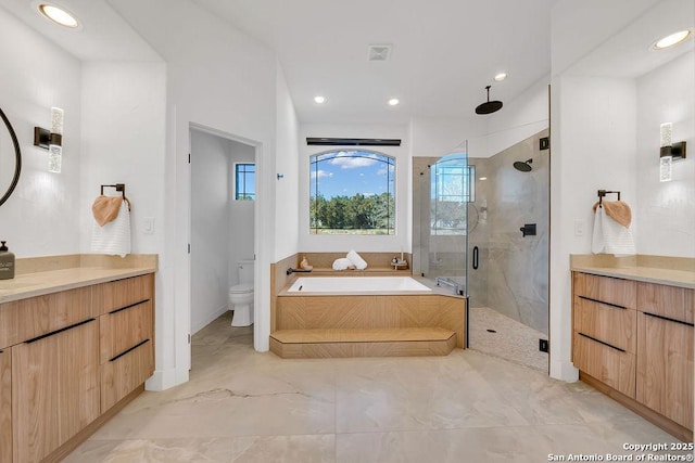 full bathroom with vanity, independent shower and bath, and toilet