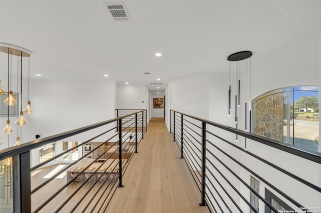 hallway with light hardwood / wood-style floors