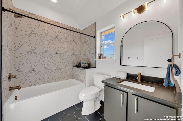 full bathroom featuring tiled shower / bath combo, vanity, tile patterned floors, and toilet