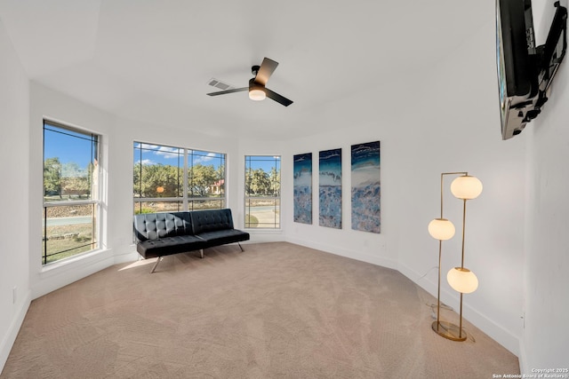 sitting room with carpet and ceiling fan