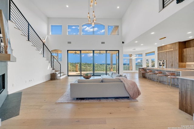 living room featuring light hardwood / wood-style floors and a high ceiling