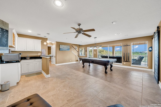 recreation room featuring sink, pool table, a textured ceiling, and ceiling fan