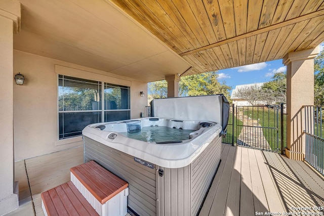 wooden terrace with a hot tub