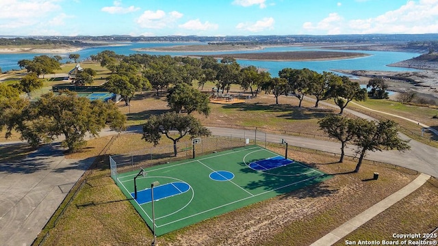 view of basketball court with a water view