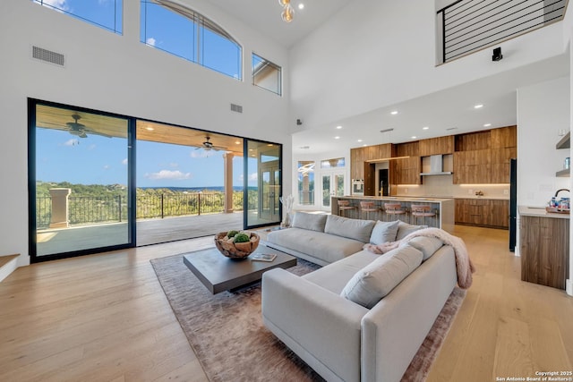 living room featuring light hardwood / wood-style floors and ceiling fan