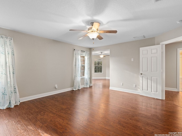 unfurnished room with dark wood-type flooring, ceiling fan, and a textured ceiling