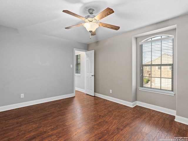 unfurnished room featuring dark hardwood / wood-style floors and ceiling fan