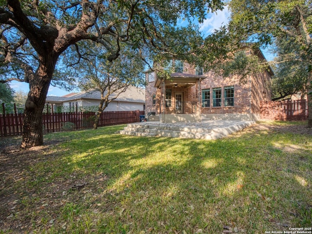 exterior space with a patio and a lawn