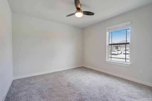 spare room featuring carpet and ceiling fan