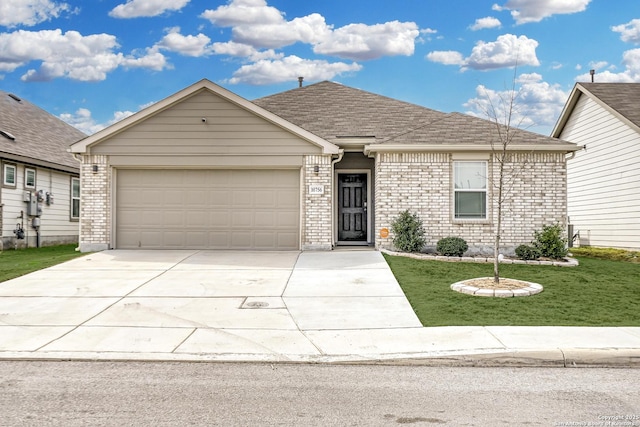 view of front of property with a garage and a front yard