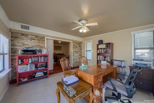 tiled office with brick wall and ceiling fan