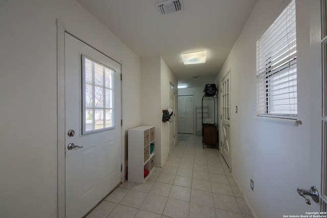 entryway with light tile patterned flooring