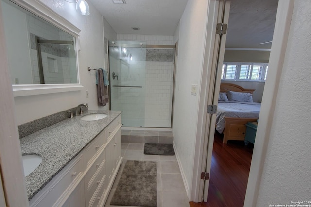 bathroom featuring vanity, tile patterned flooring, and a shower with door