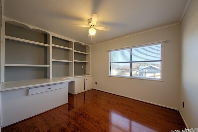 unfurnished office featuring ceiling fan, ornamental molding, and dark hardwood / wood-style flooring