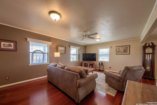 living room with ceiling fan, dark wood-type flooring, ornamental molding, and a textured ceiling