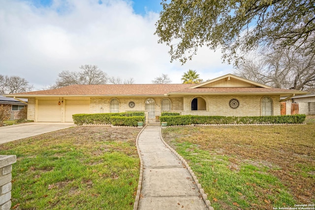 single story home with a garage and a front lawn