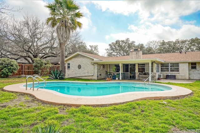 view of pool with a patio and a yard