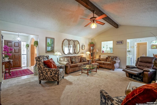 carpeted living room featuring lofted ceiling with beams, ceiling fan with notable chandelier, and a textured ceiling