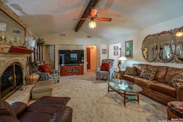 living room featuring vaulted ceiling with beams, light colored carpet, a brick fireplace, a textured ceiling, and ceiling fan