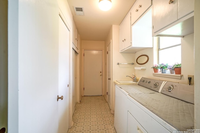 laundry room featuring cabinets, washer and dryer, and sink