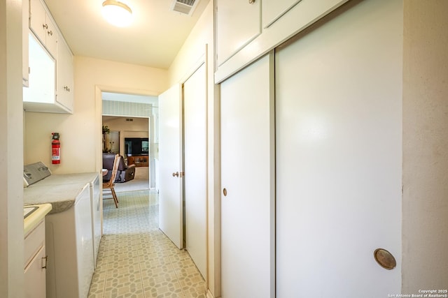 hallway featuring independent washer and dryer