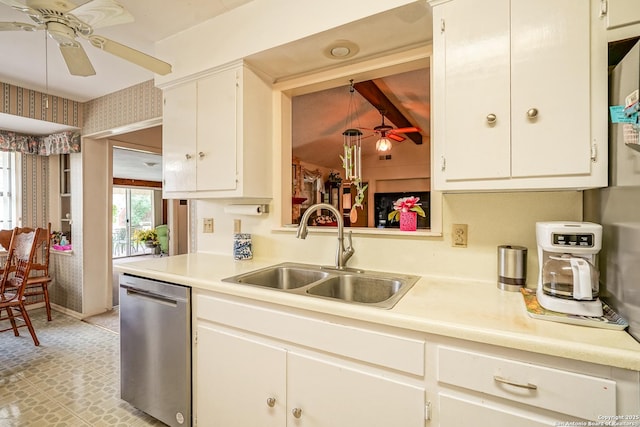 kitchen with sink, ceiling fan, white cabinets, stainless steel dishwasher, and beamed ceiling