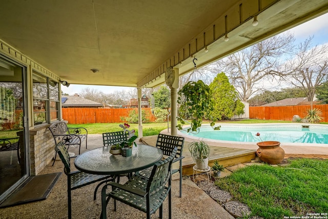 view of patio with a fenced in pool