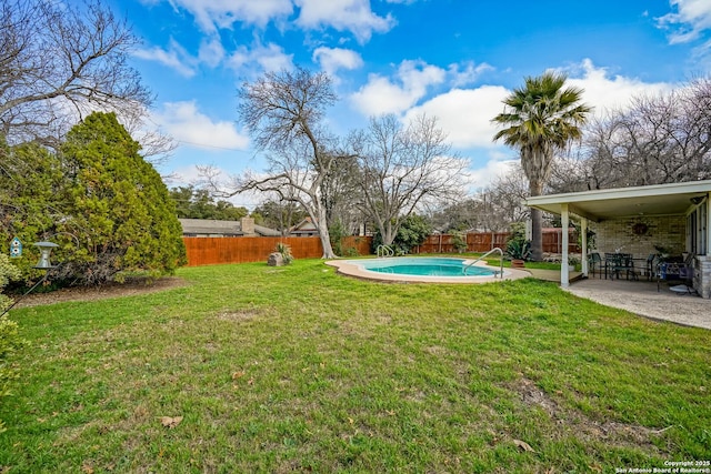 view of yard with a fenced in pool and a patio area