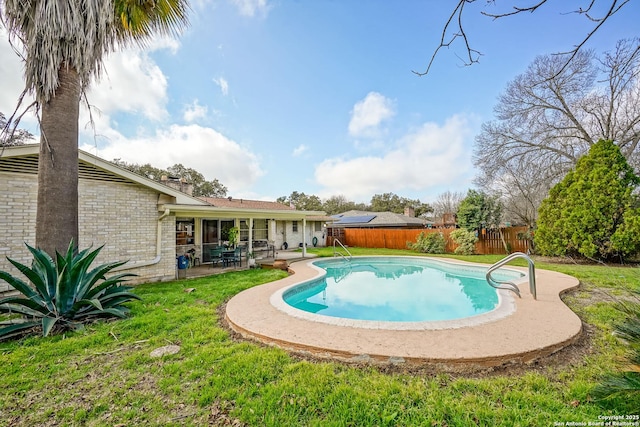 view of swimming pool with a yard and a patio