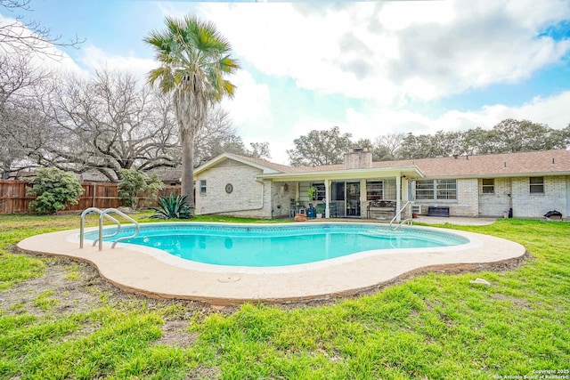 view of swimming pool with a yard and a patio