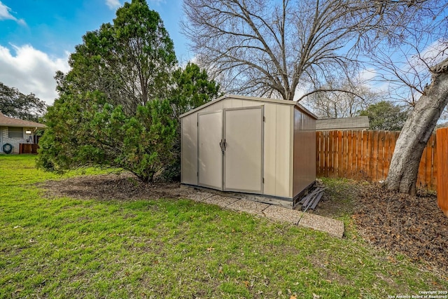 view of outbuilding with a lawn