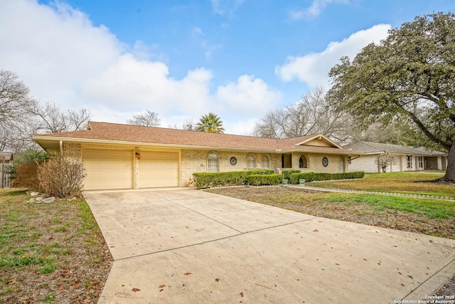 ranch-style home with a garage and a front yard