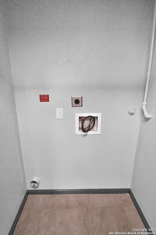 laundry area featuring washer hookup, a textured ceiling, and electric dryer hookup