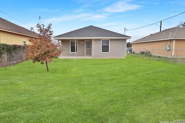 back of property featuring a yard