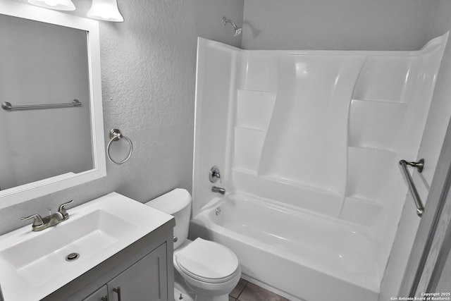 full bathroom featuring vanity, toilet, and  shower combination