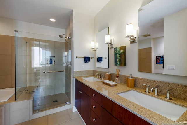 bathroom with walk in shower, tile patterned floors, and vanity