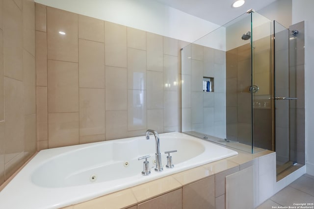 bathroom featuring tile patterned floors and separate shower and tub