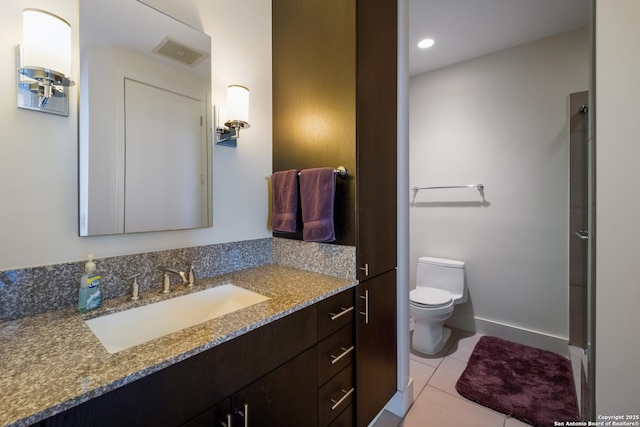 bathroom featuring tile patterned flooring, vanity, and toilet