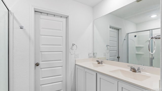 bathroom with vanity and a shower with shower door