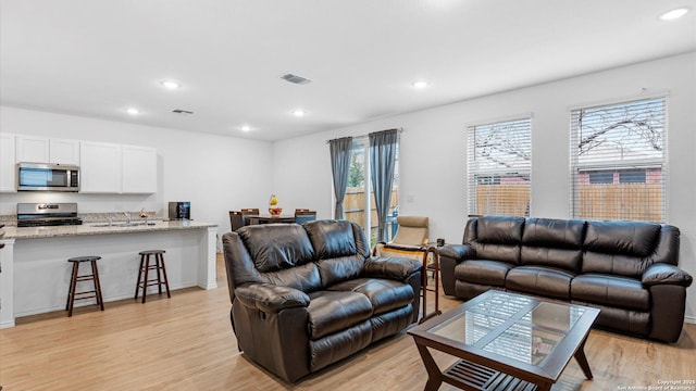 living room with light hardwood / wood-style flooring