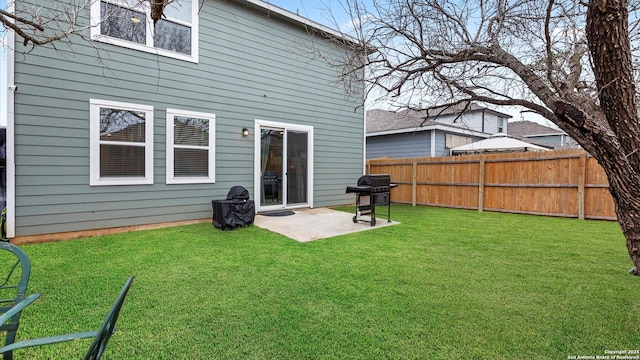 rear view of house with a yard and a patio area