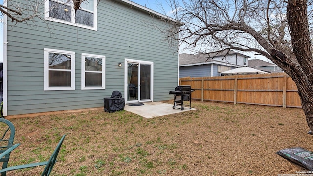 back of property featuring a yard and a patio area