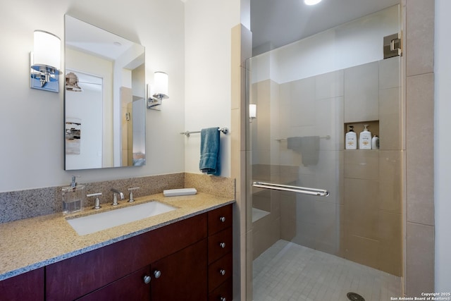 bathroom with vanity and a shower with shower door