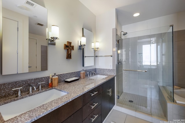 bathroom featuring vanity and a shower with shower door