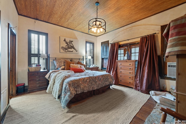 bedroom with hardwood / wood-style floors, cooling unit, wood ceiling, and a notable chandelier